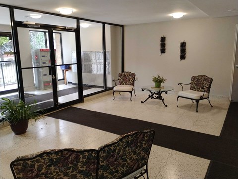 A room with a chair and a table in it.