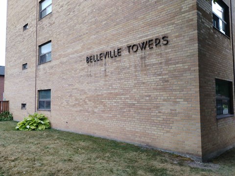 A brick building with the words "Belleville Towers" on it.