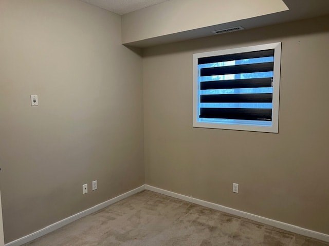 A room with a window covered by white blinds.