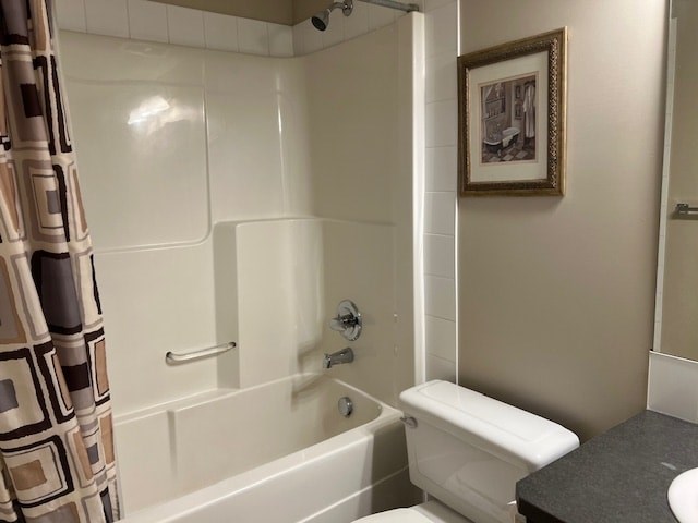 A bathroom with a white toilet, a bathtub, and a picture on the wall.