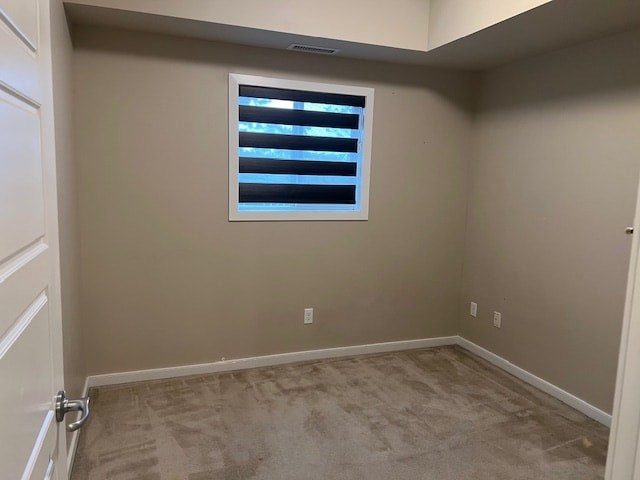 A room with a window and carpeted floor.
