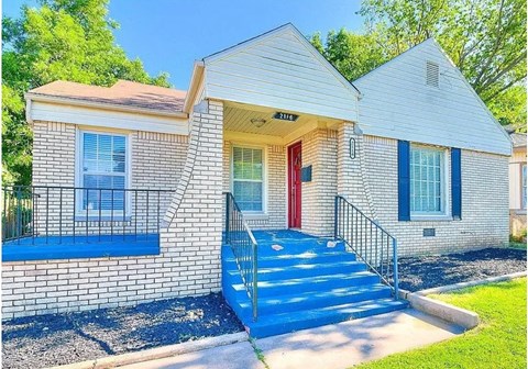 A house with a red door and a blue staircase.