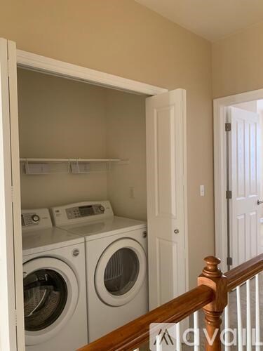 A laundry room with a washer and dryer in it.