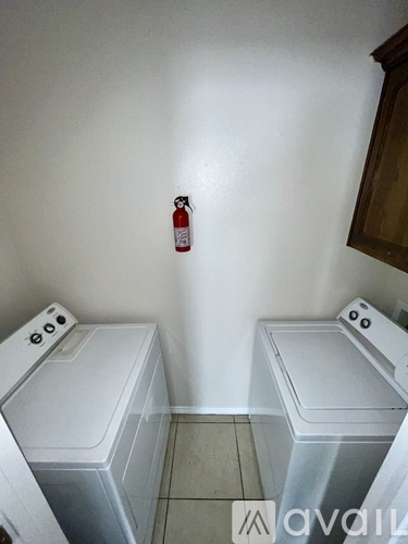 A room with a window and tiled floor.