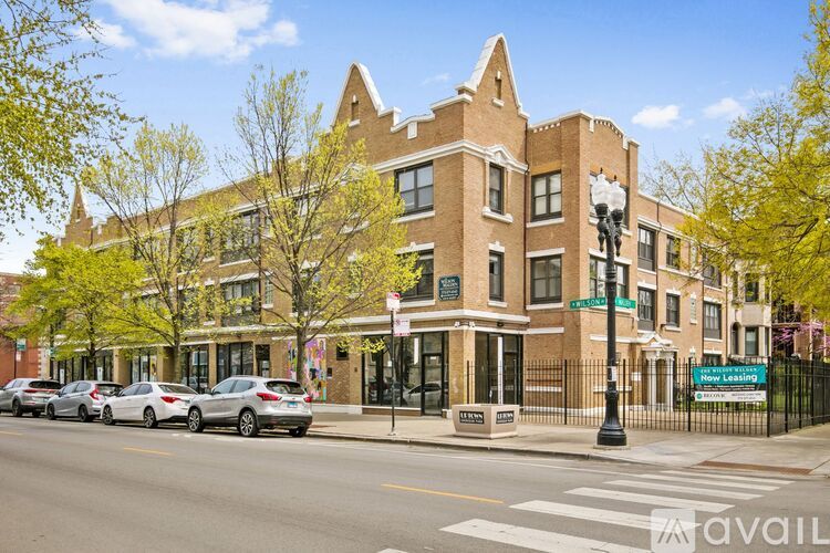 A street view of a building with cars parked in front.