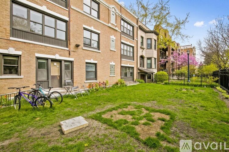 A brick building with a bicycle parked in front of it.