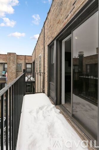A balcony with a black railing and a glass door.
