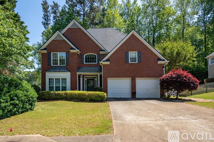 A red brick house with a white garage door.