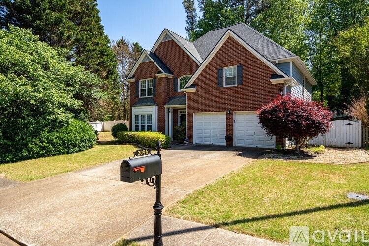 A brick house with a mailbox in front.