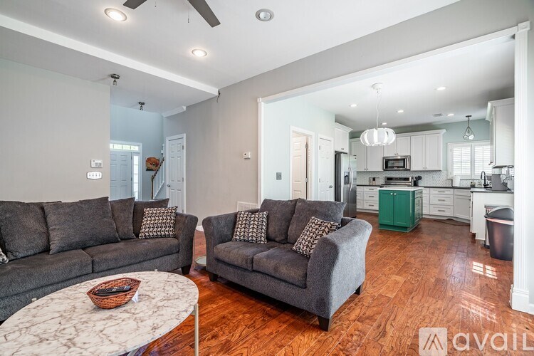 A living room with a grey couch and a white coffee table.