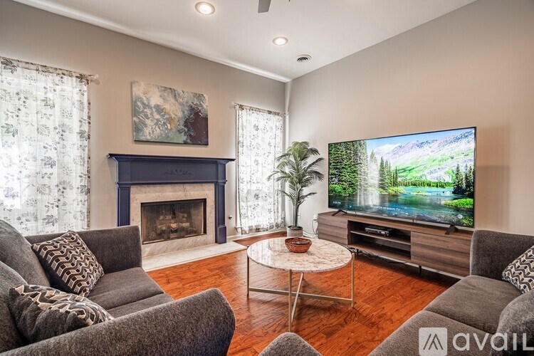 A living room with a fireplace and a television.