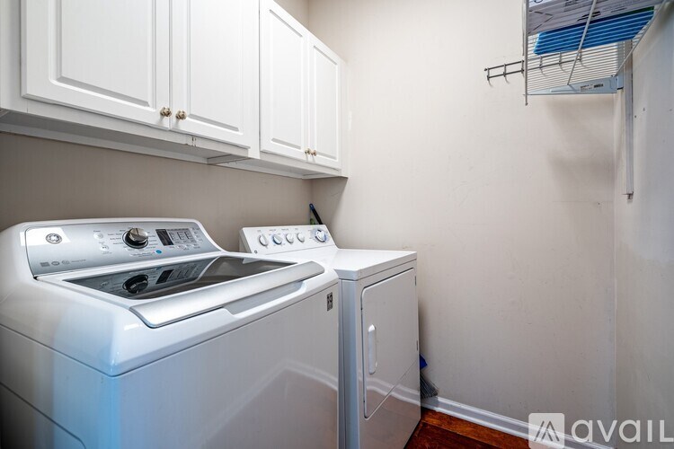 A white washing machine and dryer in a laundry room.