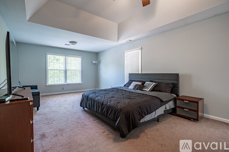A bedroom with a large bed and a television.