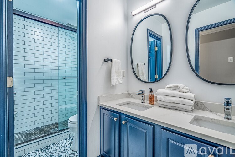 A bathroom with blue doors and a white sink.