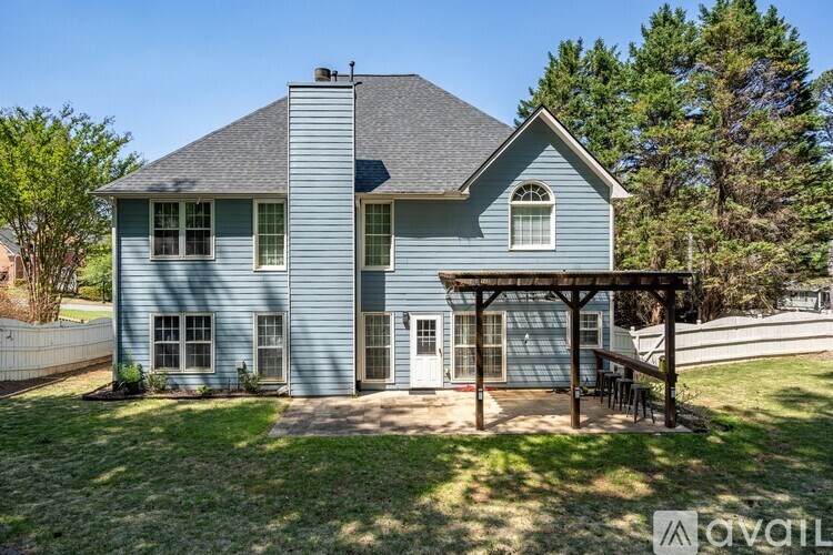 A blue house with a white door and windows.