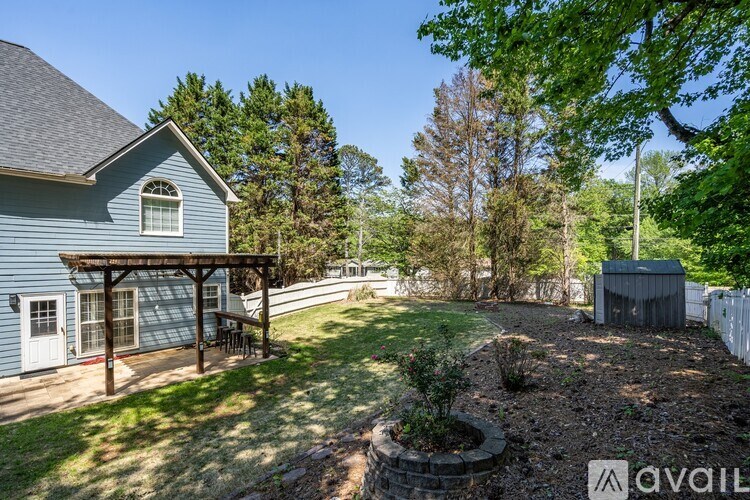 A house with a blue exterior and a covered patio area.