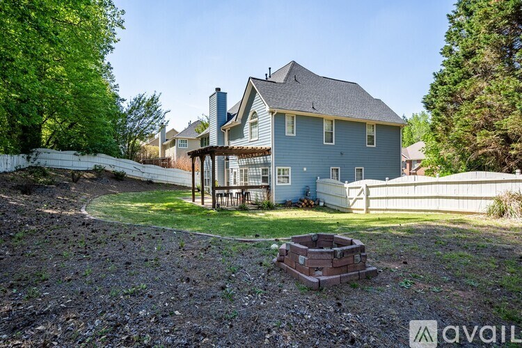 A house with a blue exterior and a white fence.