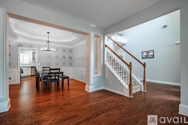 A living room with a dining table and chairs.