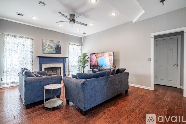 A living room with a fireplace and a television.