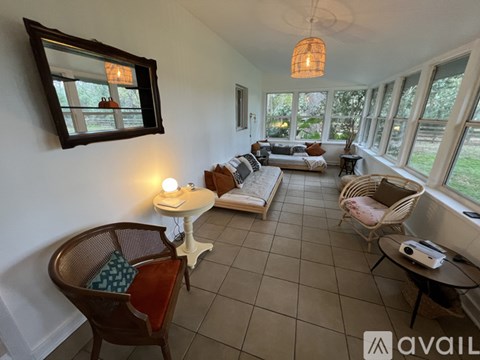 A living room with a sofa set, a coffee table, and a chair.
