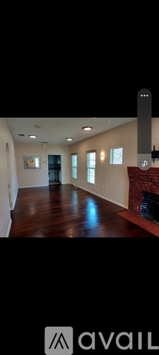 A room with a fireplace and a painting on the wall.