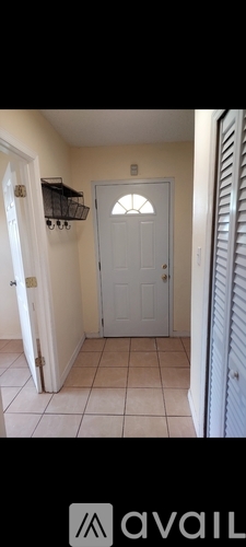 A white door is in the middle of a hallway.