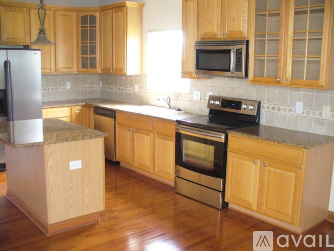 A kitchen with wooden cabinets and a black oven.
