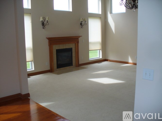A living room with a fireplace and a chandelier.