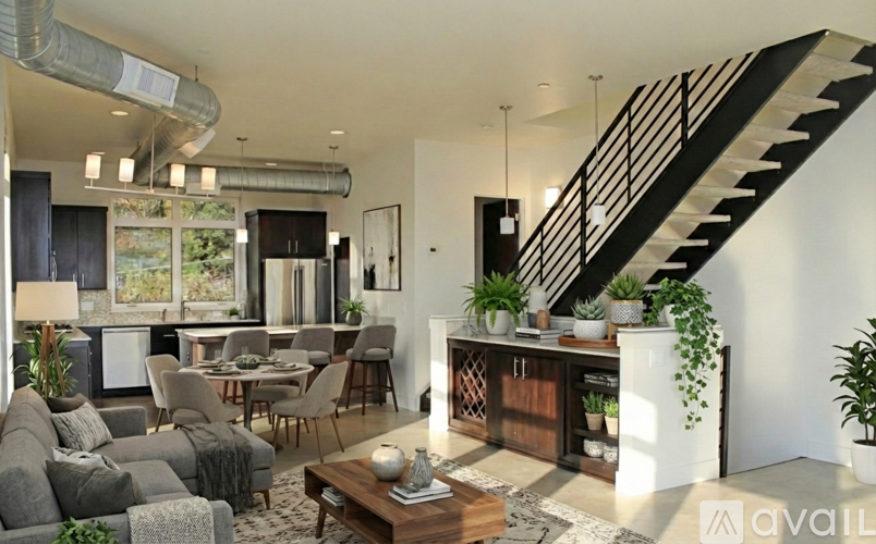 A modern living room with a staircase and a television.