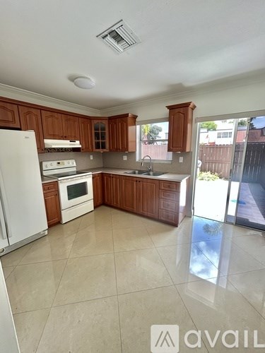 A room with a large window and a tiled floor.
