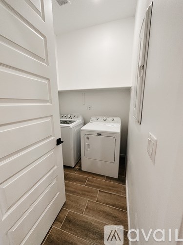A small laundry room with a washer and dryer.