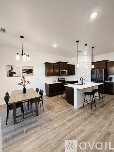 A modern kitchen with a dining table and chairs.