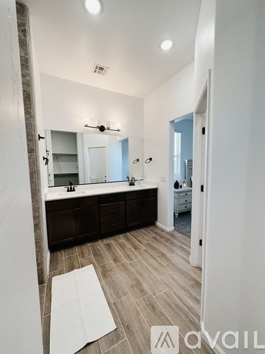 A bathroom with a large mirror and double sinks.