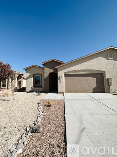 A house with a garage and a driveway in front of it.