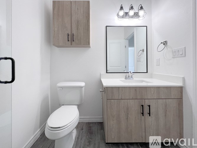 A white toilet sits next to a sink in a bathroom.