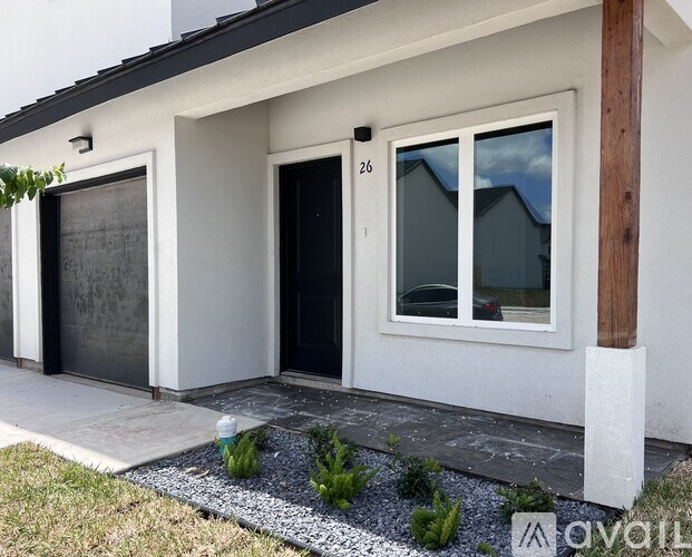 A modern house with a black door and a window with a wooden frame.
