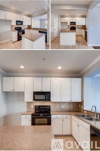 A kitchen with white cabinets and a black stove top oven.