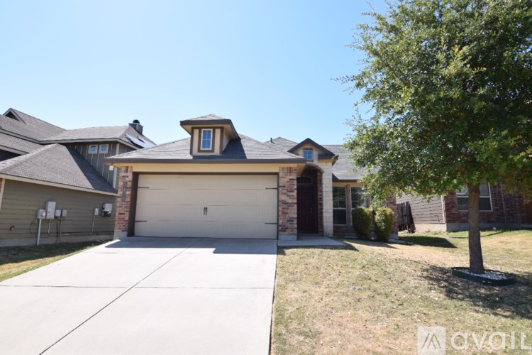 A house with a red door and a brown garage door.