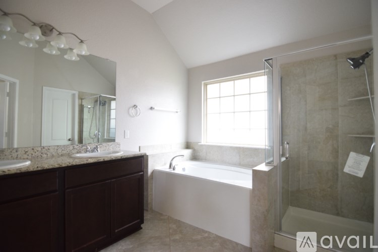 A kitchen with a granite countertop and wooden floors.