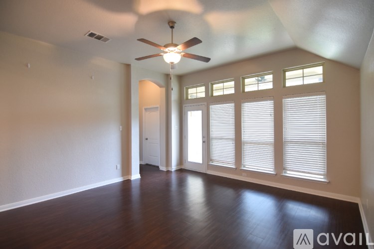 A room with a window and carpeted floor.