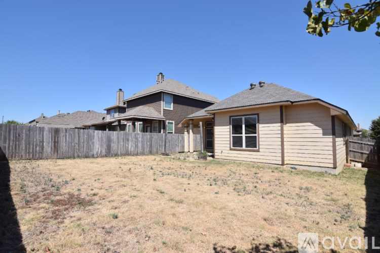 A patio with a table and chairs is visible through a sliding glass door.