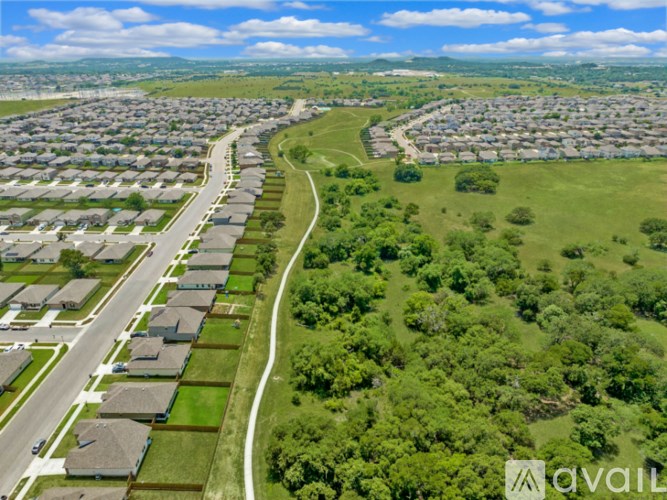A bird's eye view of a residential area with houses and a road.