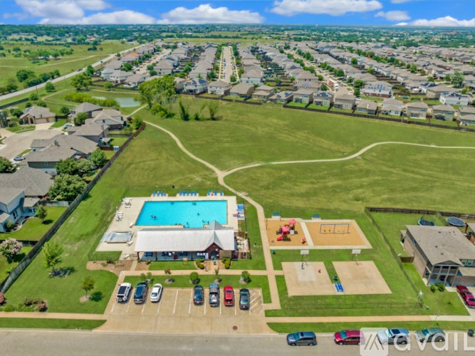 An aerial view of a neighborhood with a swimming pool and a basketball court.