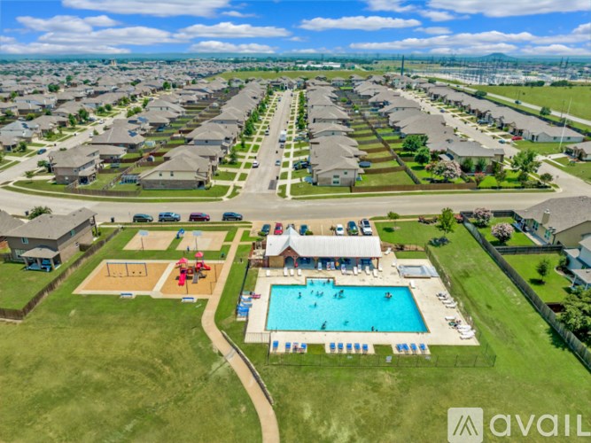 A bird's eye view of a residential area with a swimming pool and a playground.