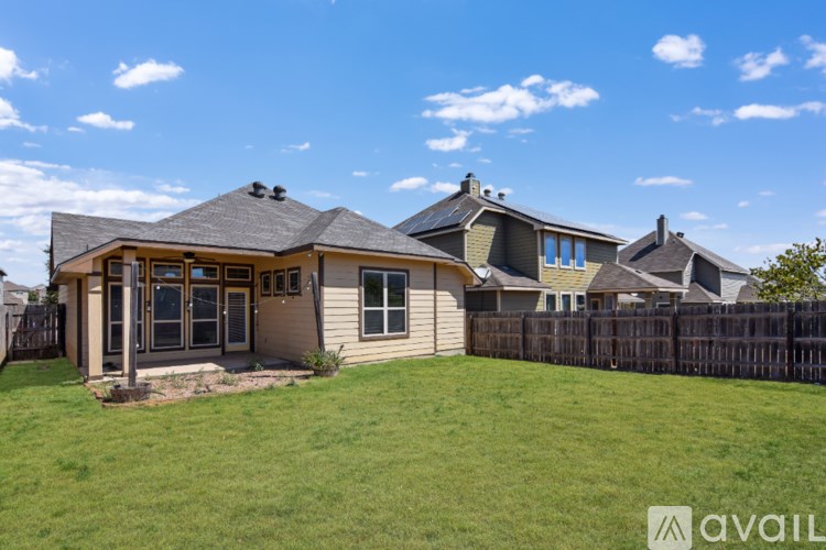 A house with a large lawn in front of it.