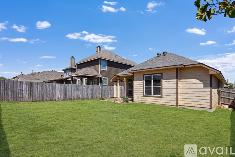 A house with a fence and a green lawn is available for sale.