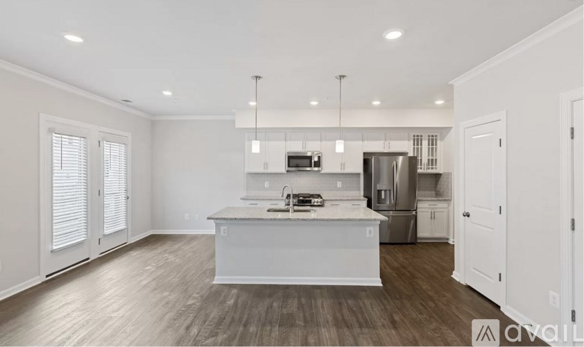 A modern kitchen with white cabinets and a center island.