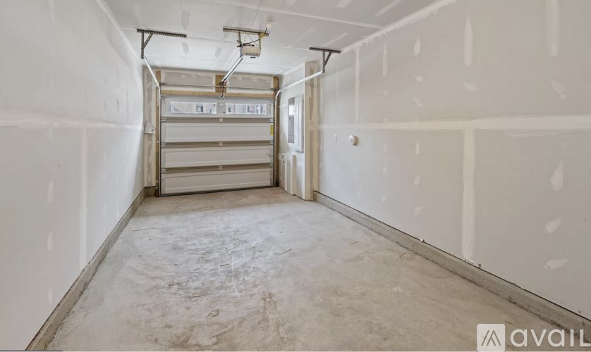 A room with white walls and a concrete floor is available for rent.