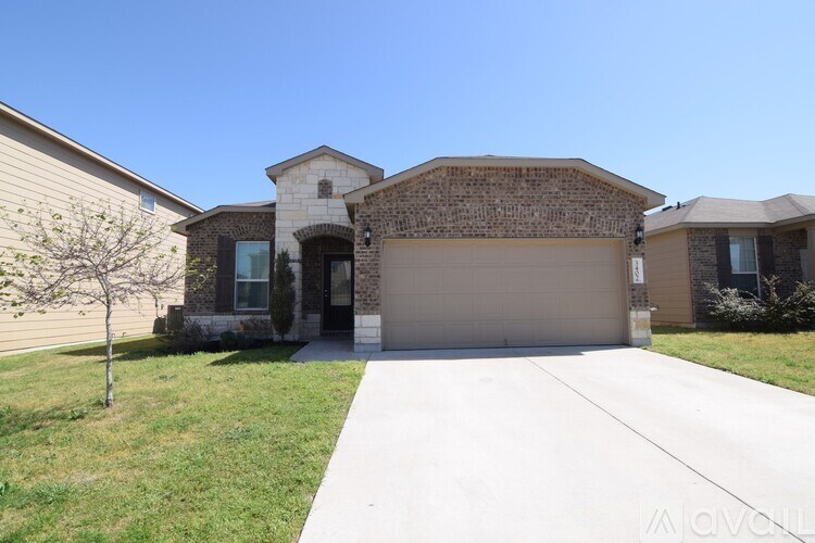 A house with a garage and a driveway in front.