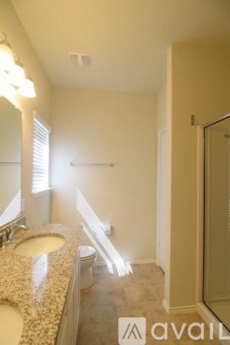 A bathroom with a sink, mirror, and toilet.